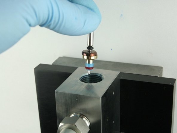 Put the point of the valve stem into the valve body.