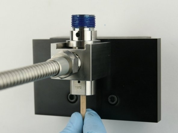 Remove the old valve components from the valve body with the included dowel.