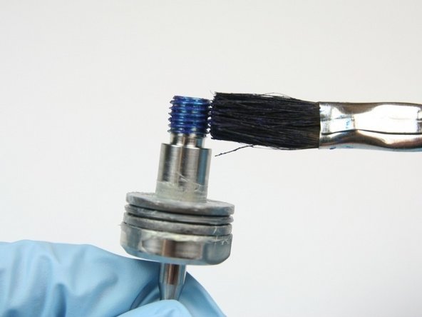 Apply Blue Goop to threads of swivel shaft