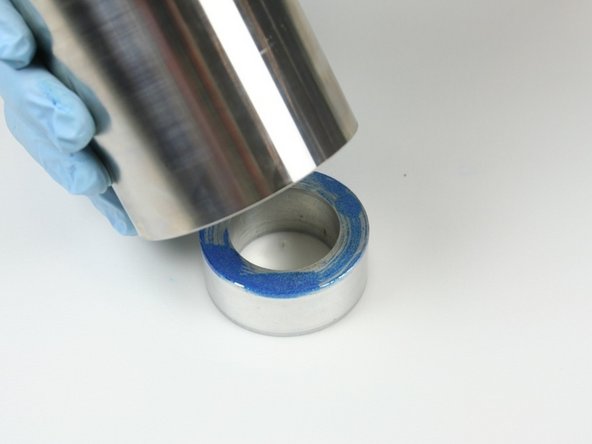 Flip the high-pressure cylinder and place it onto the locator tool.