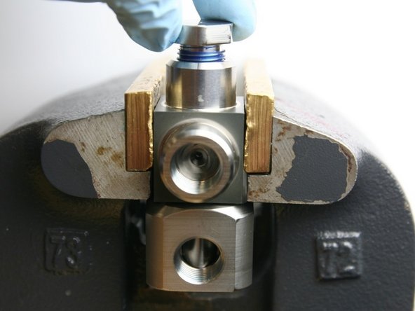 Unthread the thrust nut from the swivel housing.