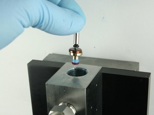 Put the point of the valve stem into the valve body.