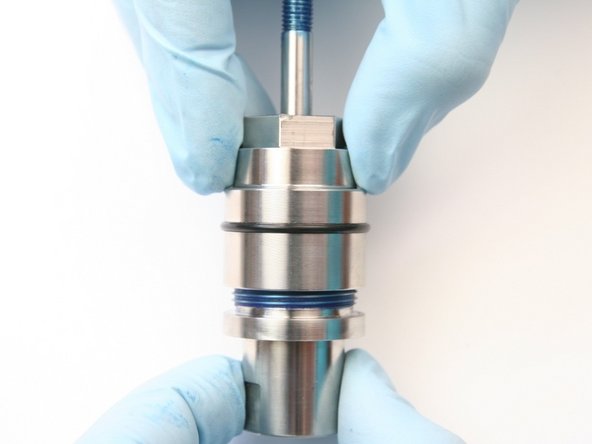 Unthread bearing half from seal half of the swivel housing.