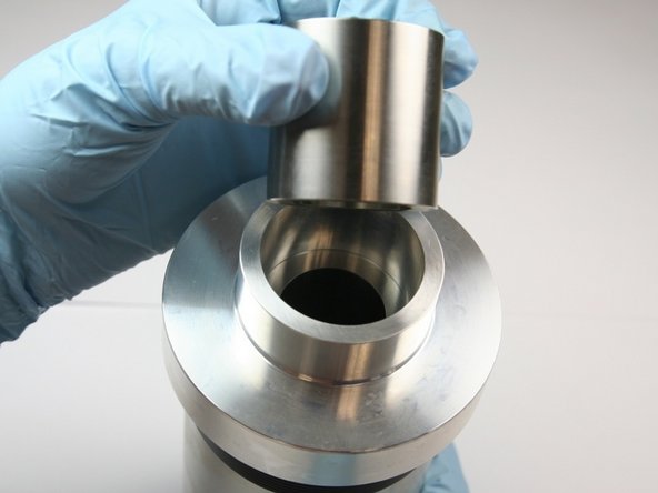 Put the sleeve into the seal guide tool with the tapered end side facing up.