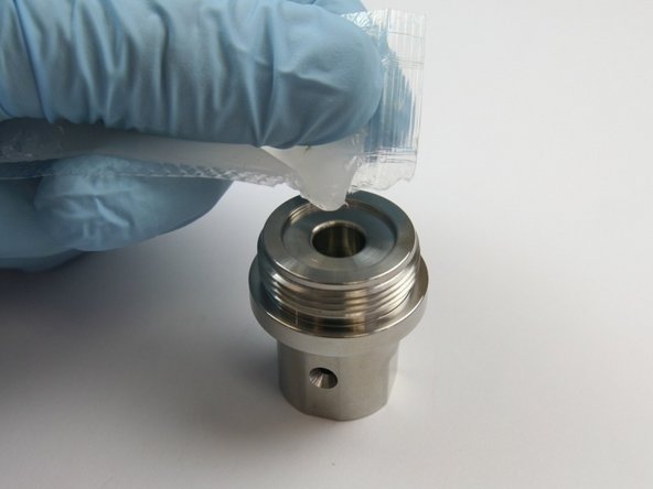 Apply a layer of high vacuum grease into the cavity of the seal half of the swivel housing.