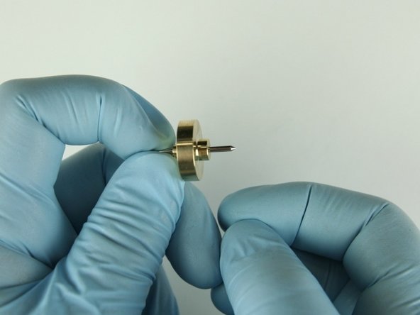 Slide the needle bearing with the smaller stepped side onto the needle point first.