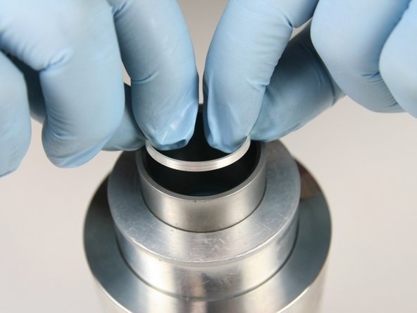 Hold the sleeve down against the cylinder with one hand to be sure it doesn't raise up while installing the seal.