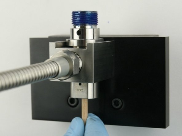 Remove the old valve components from the valve body with the included dowel.