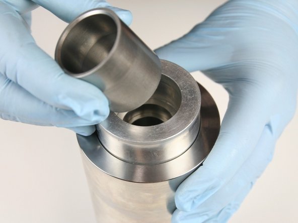 Put the sleeve into the locator tool with the tapered end up.