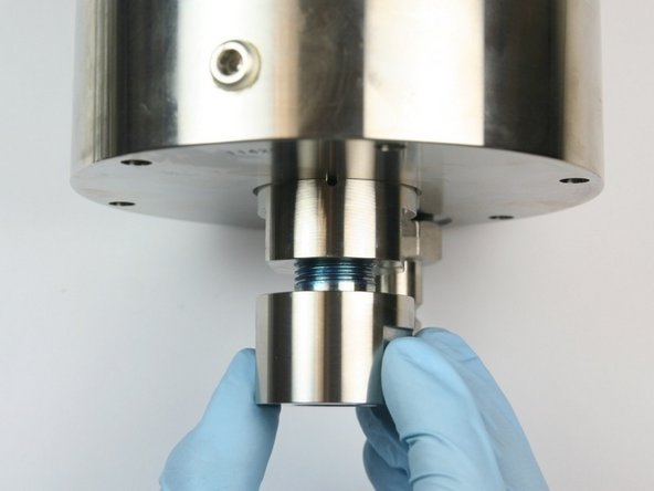 Thread the outlet body into the bottom of the check valve body.