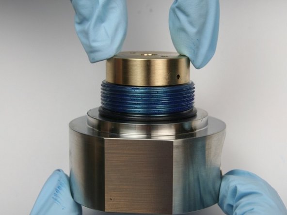 Put the new back-up bearing (cupped side down) on the top of the seal half of the swivel housing.