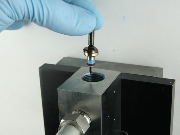 Put the point of the valve stem into the valve body.