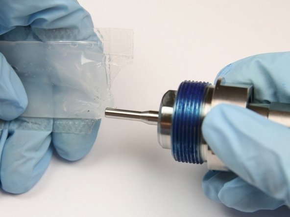 Apply high vacuum grease to stem of swivel shaft