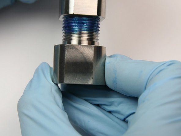 Unthread outlet fitting from bleed down valve body