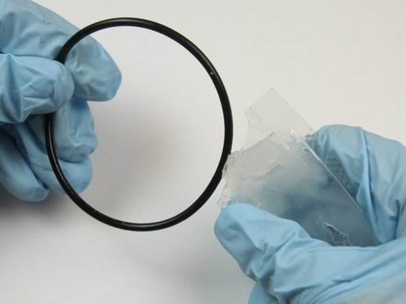 Apply high vacuum grease to the biggest O-ring from the kit.