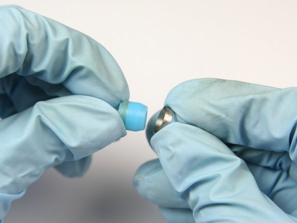 Put the hoop with the sharp (tapered) end onto the non O-ring side of the high-pressure seal.