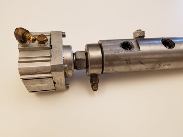 With manifold removed from pump, place manifold in a heavy bench vise