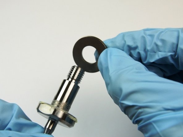 Place the first thrust washer onto the swivel shaft.