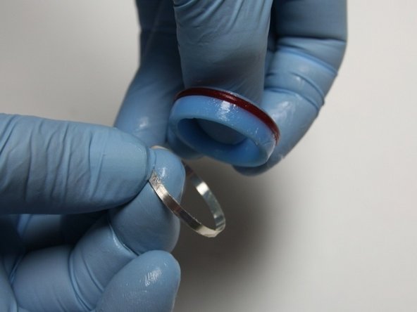 Put the hoop with the sharp (tapered) end down onto the back of the seal.