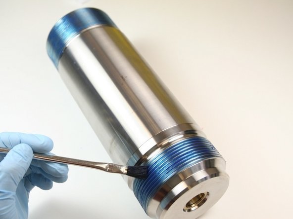 Apply Blue Goop to the threads of the high-pressure cylinder.