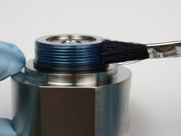 Apply blue goop to the external threads on the seal half of the swivel housing.