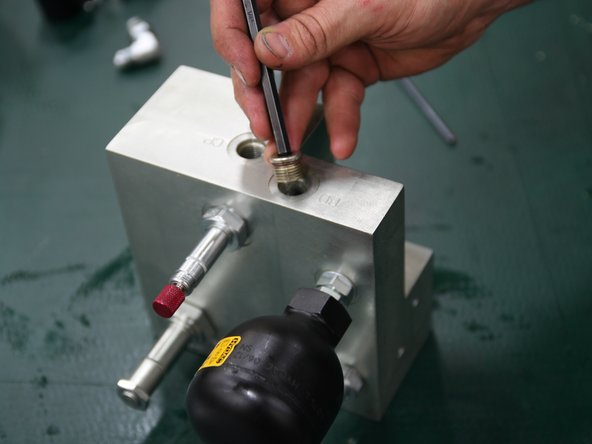 Install plug (6MBP) into port stamped BD on top of new manifold.