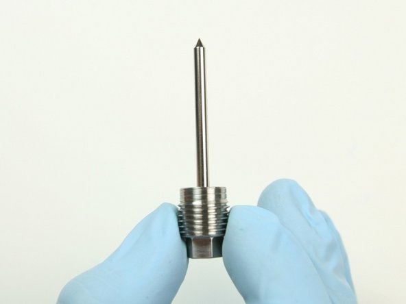 Slide the back-up screw on to the needle so the flat end of the needle is flush with the non threaded part of the back-up screw.