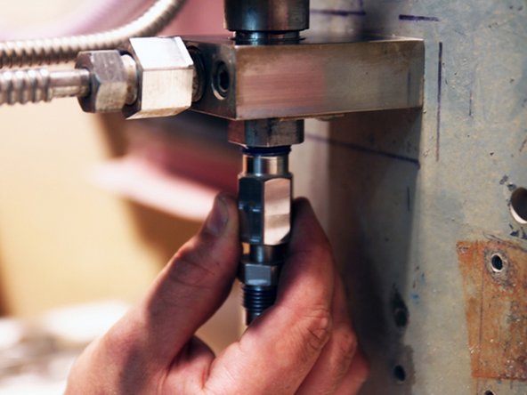 With actuator turned ON, thread nozzle tube into bottom of valve body.