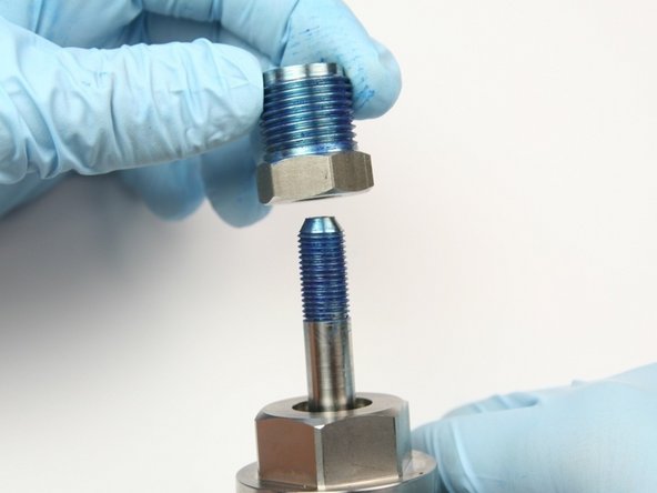 Put the high-pressure gland onto the swivel shaft with the threads up.