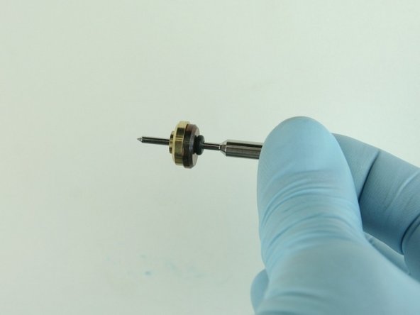 Slide thebrass back-up ring on to the valve stem point with the chamfer side away from the stainless steel back-up ring.