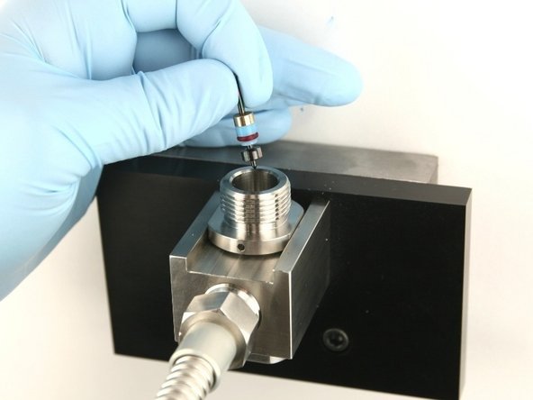 Put the poppet stem, with the point down, at the top of the valve body.