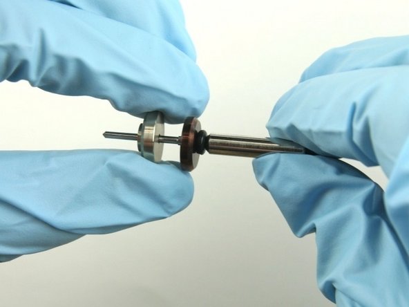 Slide the bronze back-up ring on to the valve stem point with the chamfer side away from stainless steel back-up ring.