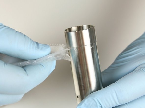 Apply a light coat of high vacuum grease to both ends of the spacer tube.