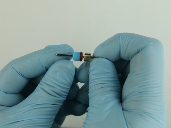 With the O-ring towards the bushing stem, slide the  high-pressure valve seal onto the poppet needle behind the bushing stem.