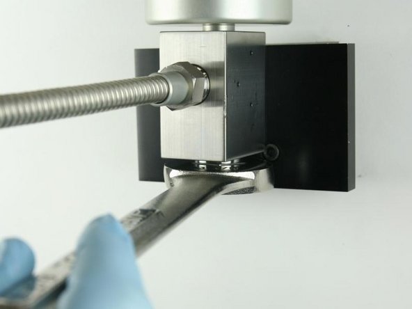 Tighten the high-pressure gland fitting using a 1-1/8&quot; wrench.