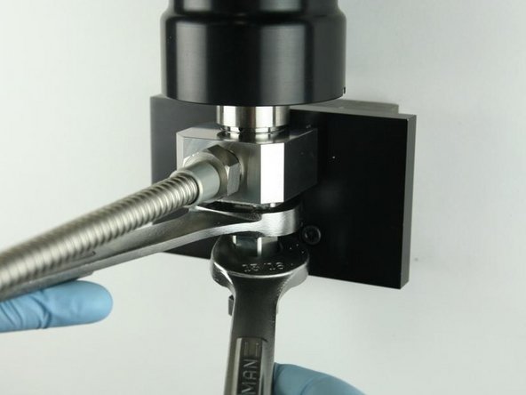 Tighten the adapter into the valve body using a 1&quot; and 13/16&quot; wrench.