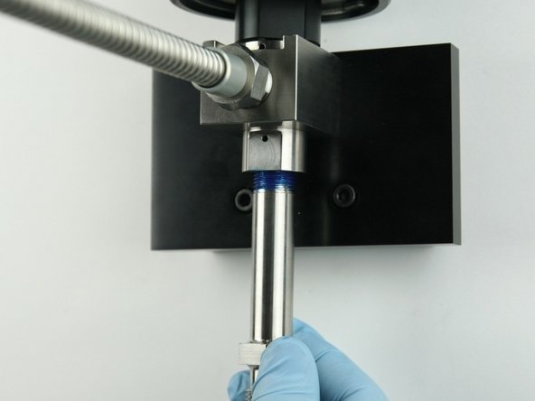 Thread the nozzle tube into the bottom of the valve body.