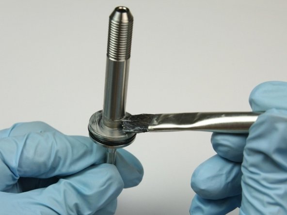 Apply a layer of lithium grease to the base of the swivel shaft.