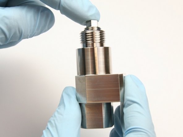 Push seal backup screw inside of valve body until it bottoms out