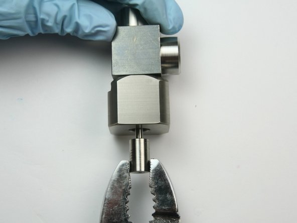 Remove the swivel shaft from the collar by grasping with a set of pliers and pulling.