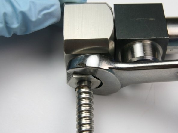 Tighten the high-pressure gland into the swivel collar using a 5/8&quot; wrench.