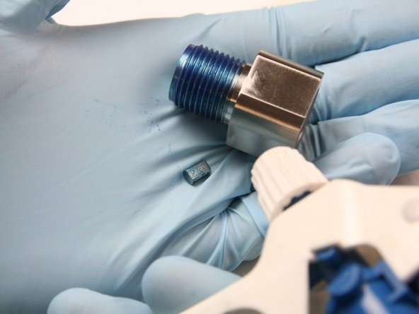 Clean the outlet adapter and the flow reducer of all Blue Goop with isopropyl alcohol.