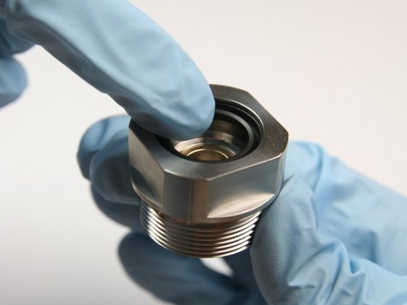 Put the wiper into the top of the bearing half of the swivel housing with the tapered end down.