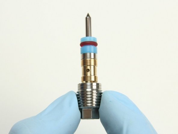 Place the high-pressure seal assembly onto the point of the needle with the hoop, first.