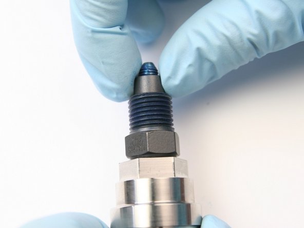 Uthread the high-pressure collar from the threads of the swivel shaft.