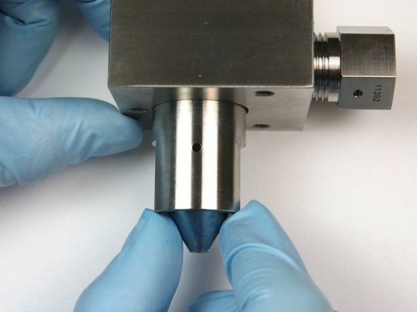 Put the high-pressure seat at the bottom of the bleed-down valve body with the pointed end out.