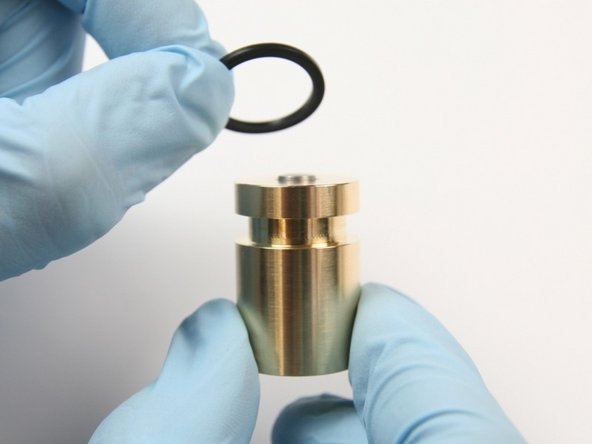 Slide the new back-up ring (flat) to the groove of the piston.