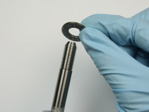 Slide the thrust bearing onto the swivel shaft.