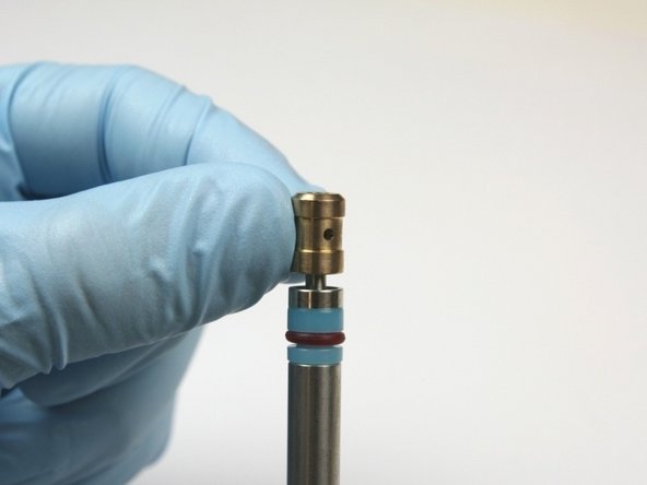 Slide the bushing on the bleed-down valve tool with the chamfer side away from the hoop.