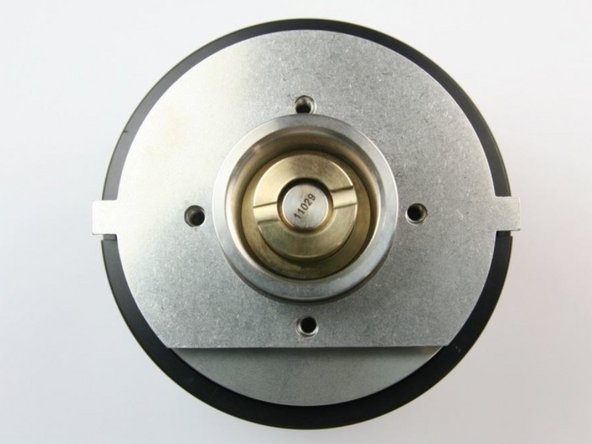 After all the internal components have been re-installed, place the retainer cap with the tabs in the slots on the housing.